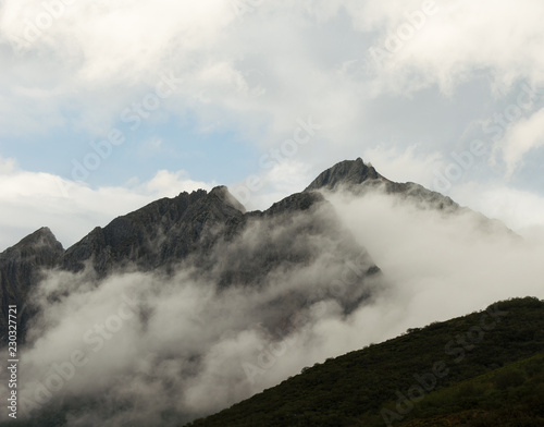 Amazing shot of Torres mountain peak surrounded with light clouds. Asturias, Spain.