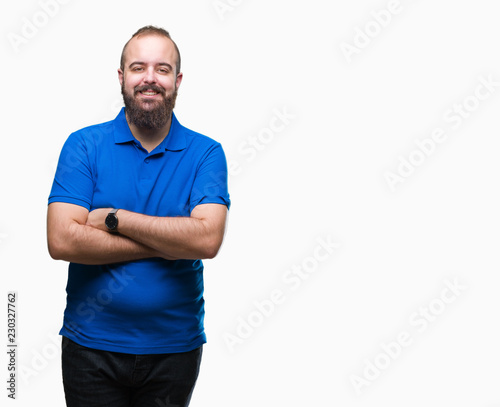 Young caucasian hipster man wearing blue shirt over isolated background happy face smiling with crossed arms looking at the camera. Positive person.