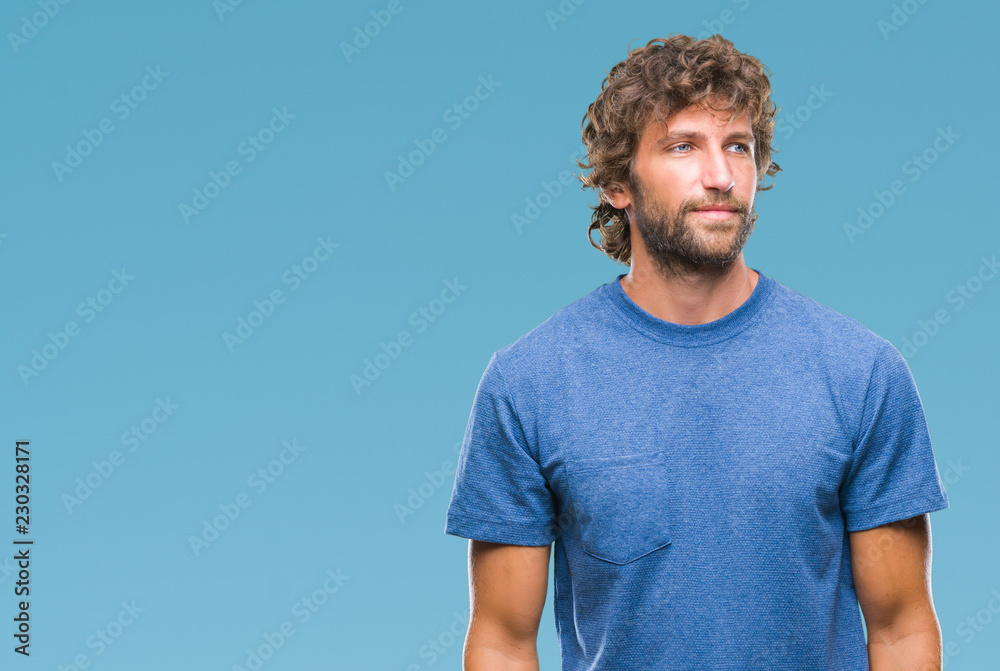 Handsome hispanic model man over isolated background looking away to side with smile on face, natural expression. Laughing confident. Handsome hispanic model man over isolated background looking away to side with smile on face, natural expression. Laughing confident.