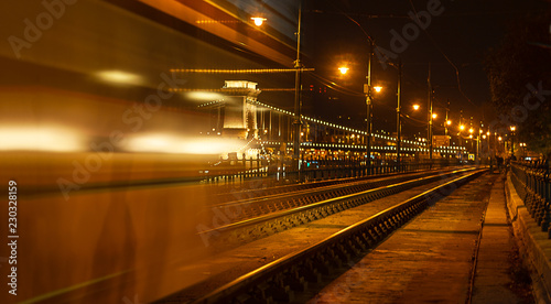 BUDAPEST, HUNGARY - October 26, 2018 Night view of the tram on the background of the Chain Bridge in Budapest, Hungary. Selective focus. Traveling to Hungary © IrynaV