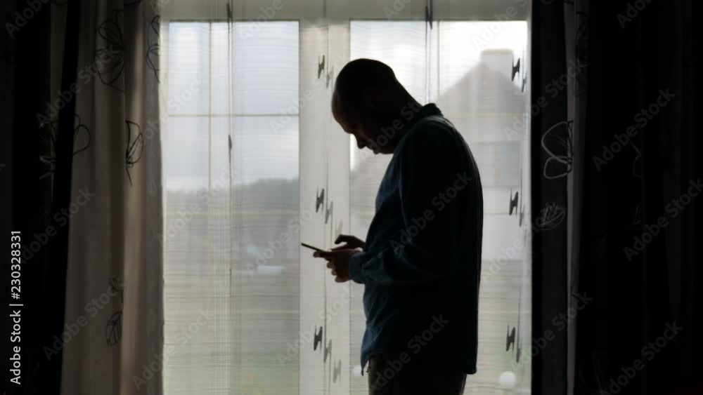 Man Typing a Message Using Mobile Phone. Man Typing a Message Using Mobile Phone.