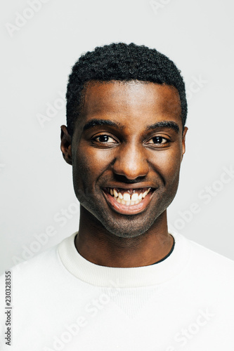 Portrait of a happy young man with a big smile, isolated on white studio background