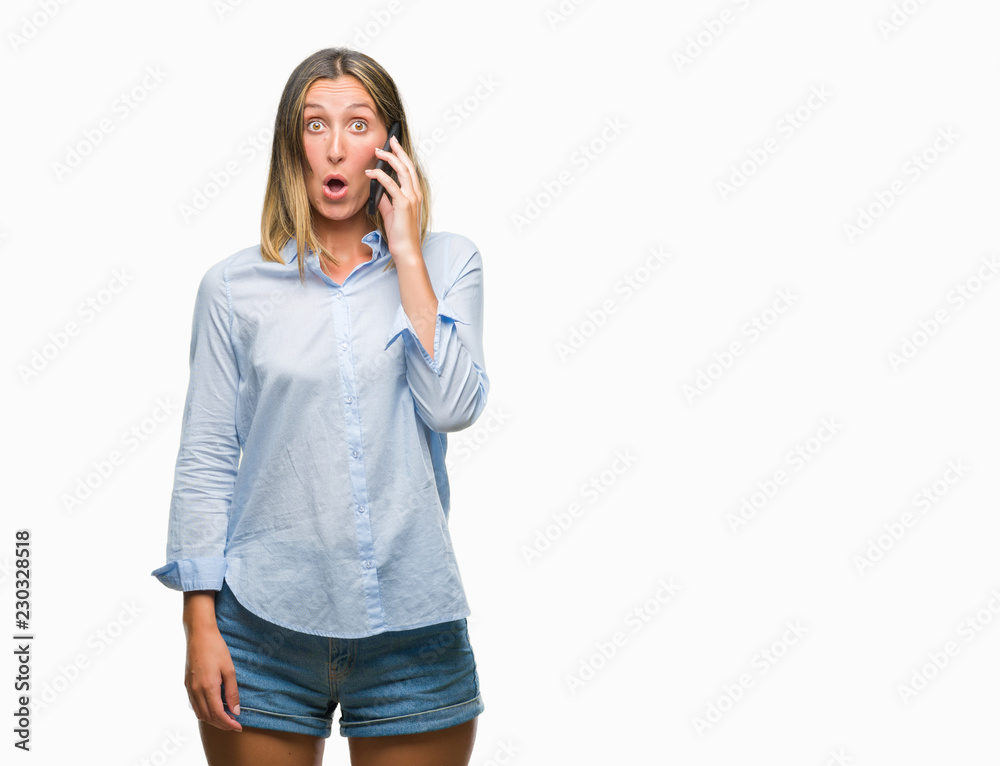 Young beautiful woman talking on smartphone over isolated background scared in shock with a surprise face, afraid and excited with fear expression Young beautiful woman talking on smartphone over isolated background scared in shock with a surprise face, afraid and excited with fear expression