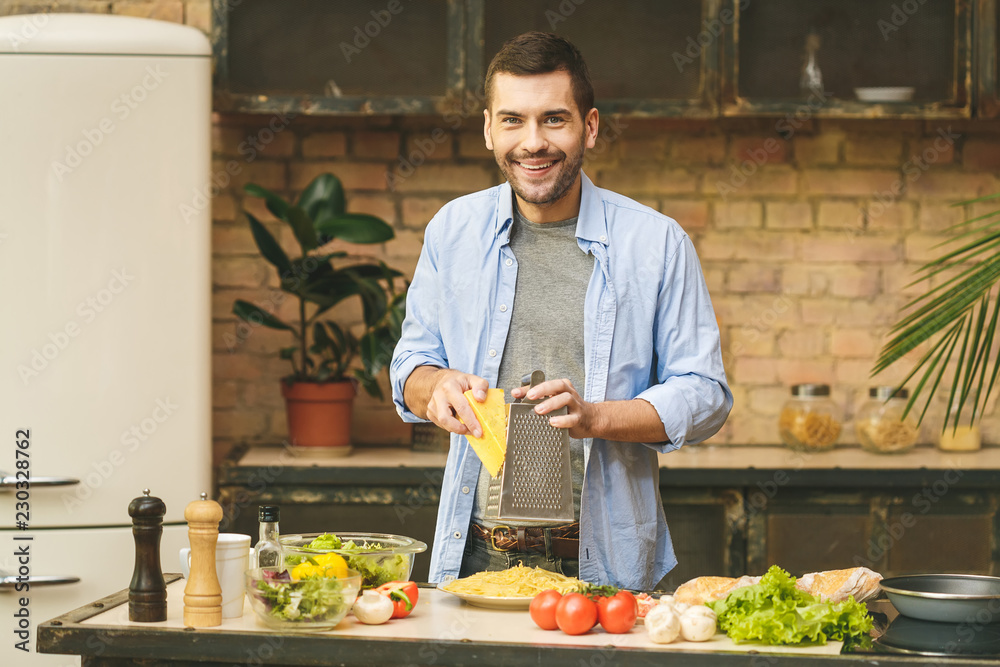 Man preparing delicious and healthy food in the home kitchen on a sunny day. Man preparing delicious and healthy food in the home kitchen on a sunny day.
