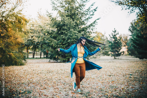 Young girl dancing in autumn park