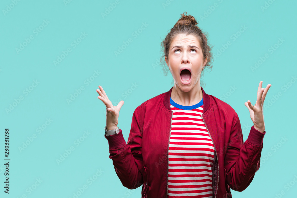 Beautiful brunette curly hair young girl wearing a jacket over isolated background celebrating mad and crazy for success with arms raised and closed eyes screaming excited. Winner concept Beautiful brunette curly hair young girl wearing a jacket over isolated background celebrating mad and crazy for success with arms raised and closed eyes screaming excited. Winner concept
