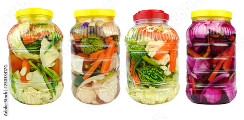 Pickled vegetables in jars isolated on white background.