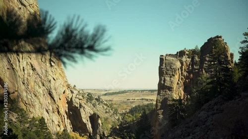 wide view of mountain with climbers on the rock face
