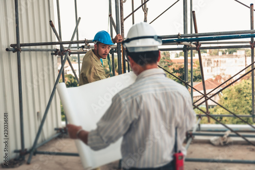 Construction Engineer is Inspection Scaffolding Installation Before Constructing Civil Work at Site While Checking on Engineering Drawing Together. Supervisor and Contractor Worker Execution