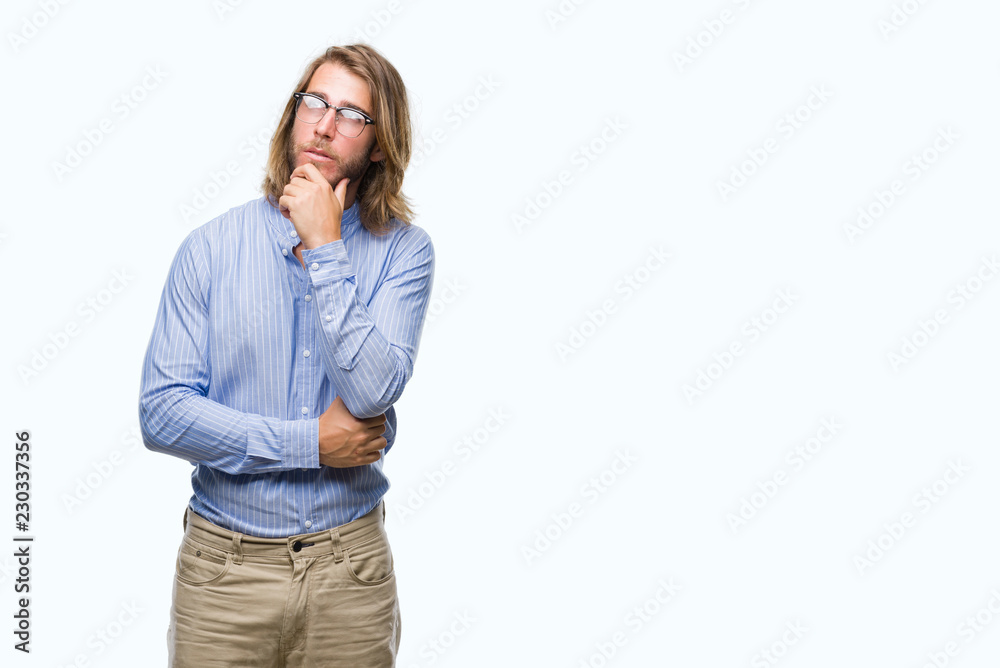 Young handsome man with long hair wearing glasses over isolated background with hand on chin thinking about question, pensive expression. Smiling with thoughtful face. Doubt concept. Young handsome man with long hair wearing glasses over isolated background with hand on chin thinking about question, pensive expression. Smiling with thoughtful face. Doubt concept.