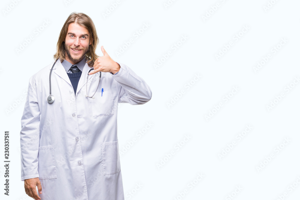 Young handsome doctor man with long hair over isolated background smiling doing phone gesture with hand and fingers like talking on the telephone. Communicating concepts.
