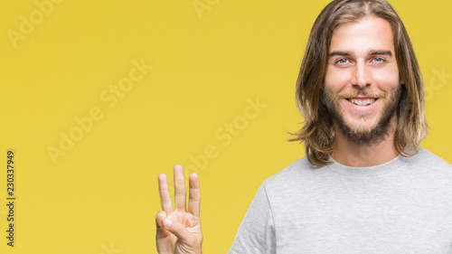 Young handsome man with long hair over isolated background showing and pointing up with fingers number three while smiling confident and happy.