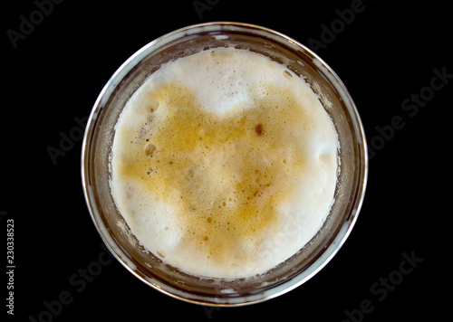 Top view of ice capuchino coffee in plastic glass isolated on black background.