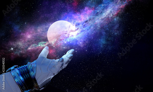 Fototapeta Naklejka Na Ścianę i Meble -  Moon planet in spaceman hand. Mixed media