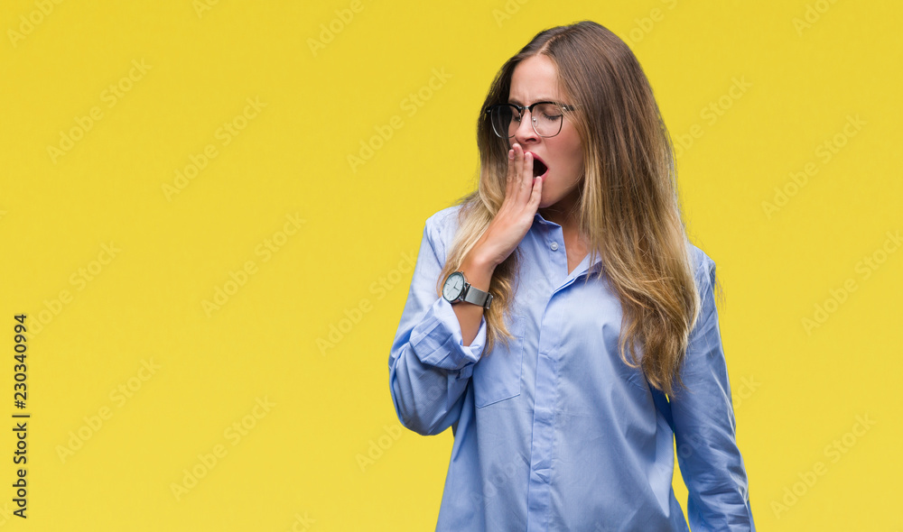 Young beautiful blonde business woman wearing glasses over isolated background bored yawning tired covering mouth with hand. Restless and sleepiness. Young beautiful blonde business woman wearing glasses over isolated background bored yawning tired covering mouth with hand. Restless and sleepiness.