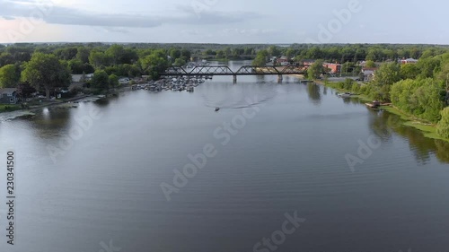 Aerial, 4k train bridge approach Chateauguay River, Quebec. photo