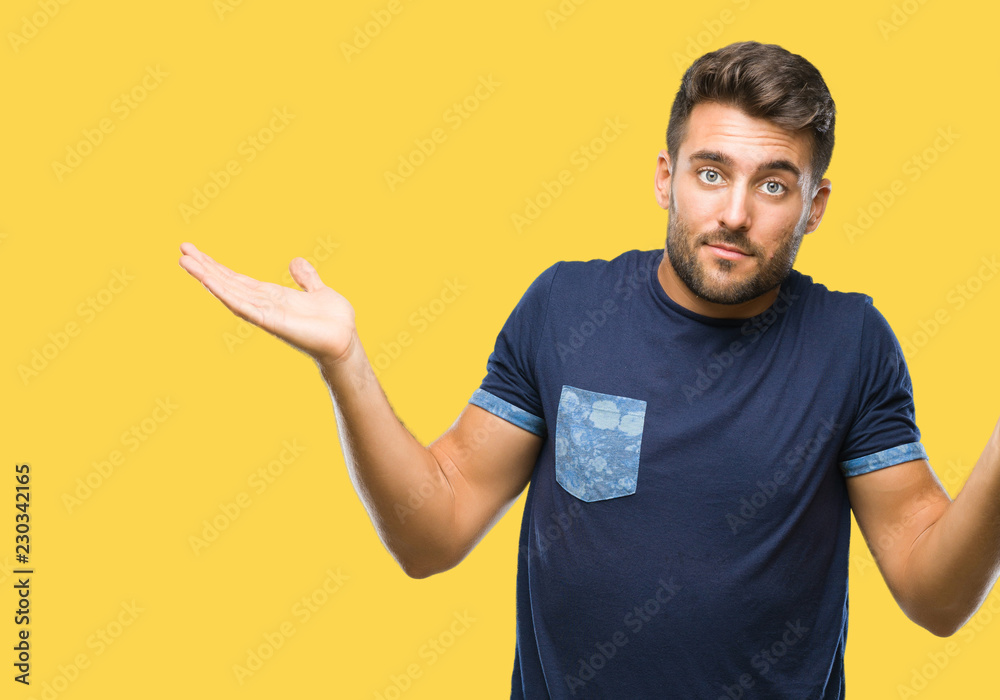 Young handsome man over isolated background clueless and confused expression with arms and hands raised. Doubt concept. Young handsome man over isolated background clueless and confused expression with arms and hands raised. Doubt concept.