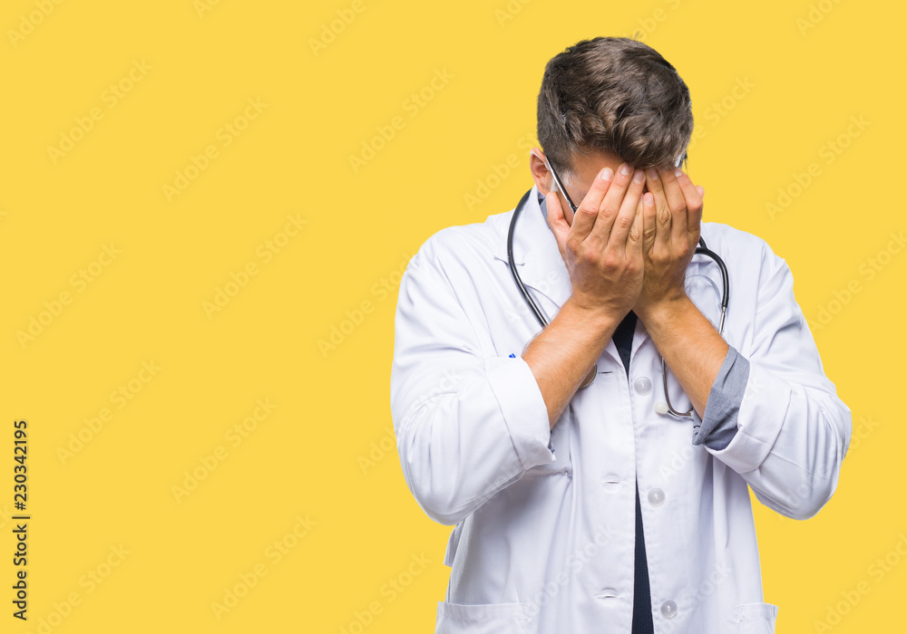 Young handsome doctor man over isolated background with sad expression covering face with hands while crying. Depression concept. Young handsome doctor man over isolated background with sad expression covering face with hands while crying. Depression concept.