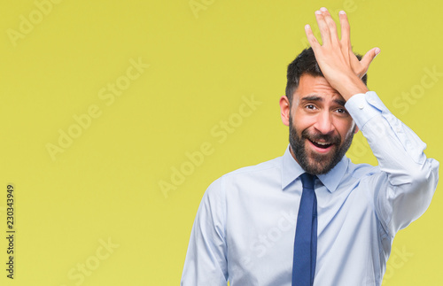 Adult hispanic business man over isolated background surprised with hand on head for mistake, remember error. Forgot, bad memory concept.