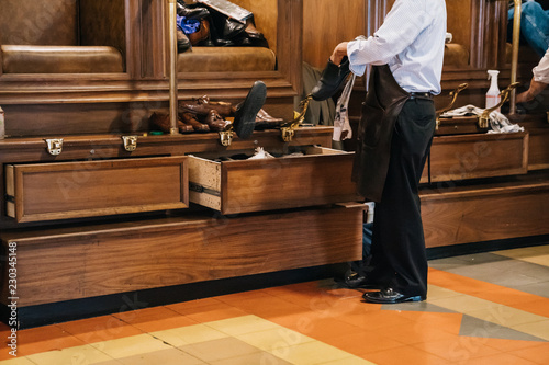 shoeshine worker is cleaning the shoes