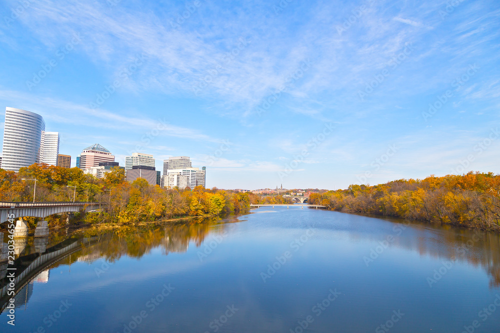 Landscape of US capital city in autumn. A view on Georgetown and Arlington neighborhoods divided by Potomac River, Washington DC, USA.
