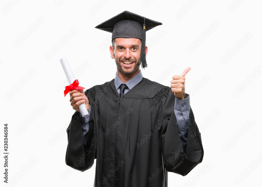 Young handsome graduated man holding degree over isolated background happy with big smile doing ok sign, thumb up with fingers, excellent sign Young handsome graduated man holding degree over isolated background happy with big smile doing ok sign, thumb up with fingers, excellent sign