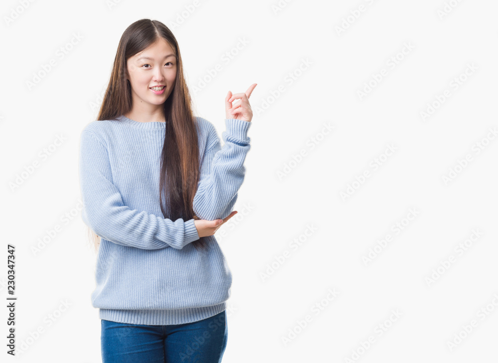 Young Chinese woman over isolated background with a big smile on face, pointing with hand and finger to the side looking at the camera. Young Chinese woman over isolated background with a big smile on face, pointing with hand and finger to the side looking at the camera.