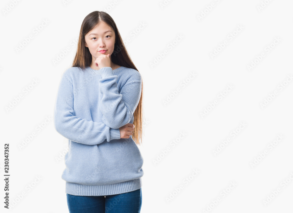 Young Chinese woman over isolated background looking confident at the camera with smile with crossed arms and hand raised on chin. Thinking positive.