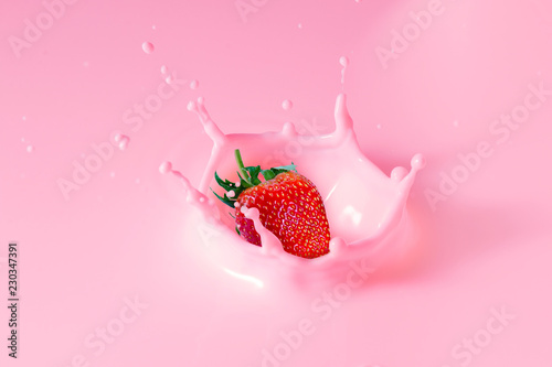 falling strawberry is splashing into milk