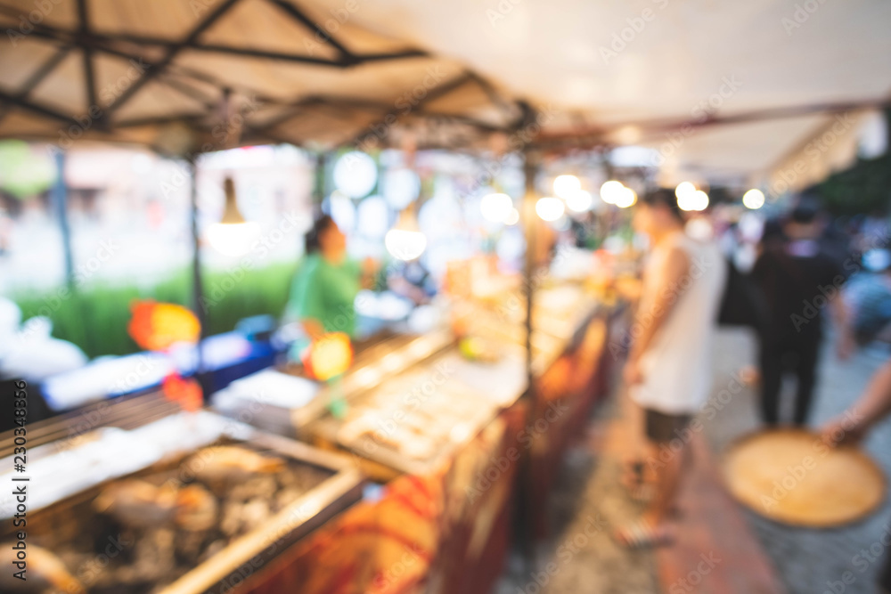 Abstract blur image of Street food in Night market with bokeh for background usage.