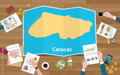 caracas venezuela capital city region economy growth with team discuss on fold maps view from top