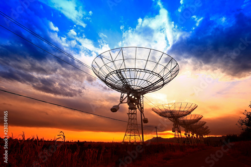 The silhouette of a radio telescope observatory