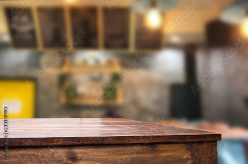 Selected focus empty brown wooden table and Coffee shop or restaurent blur background with bokeh image. for your photomontage or product display. © snowing12