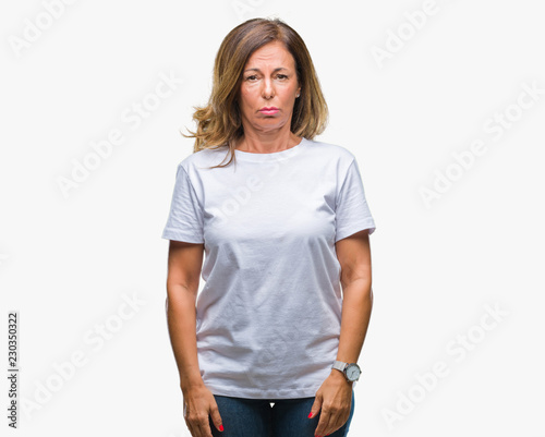 Middle age senior hispanic woman over isolated background depressed and worry for distress, crying angry and afraid. Sad expression.