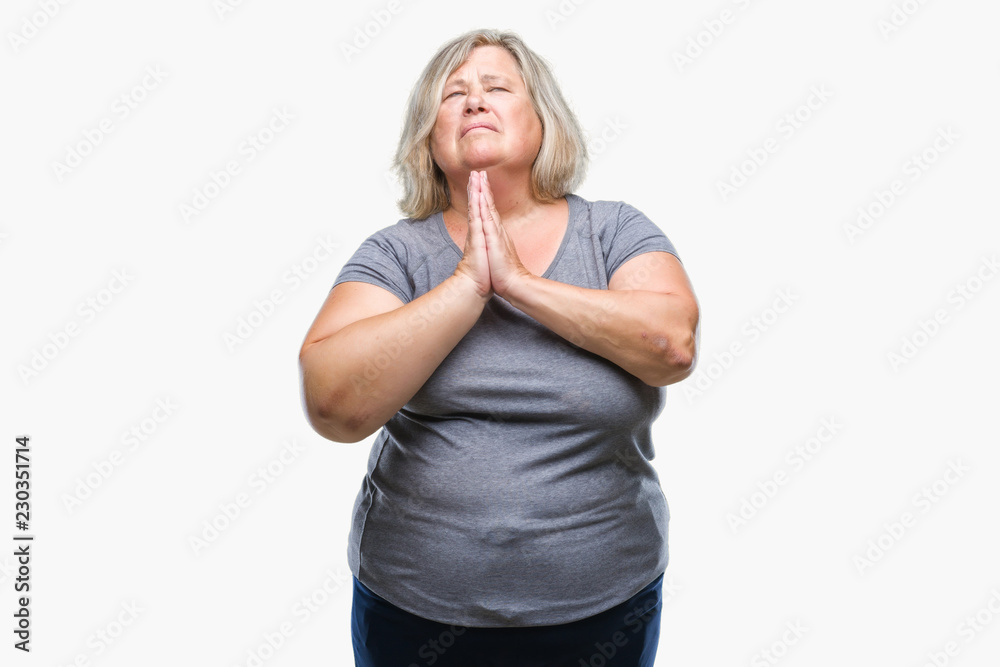 Senior plus size caucasian woman over isolated background begging and praying with hands together with hope expression on face very emotional and worried. Asking for forgiveness. Religion concept. Senior plus size caucasian woman over isolated background begging and praying with hands together with hope expression on face very emotional and worried. Asking for forgiveness. Religion concept.