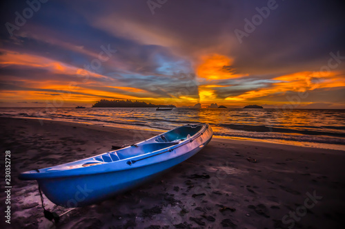 Kayak on the beach at sunset.