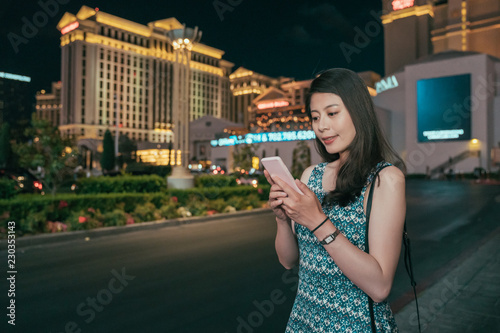 Photography girl texting sms on mobile phone app
