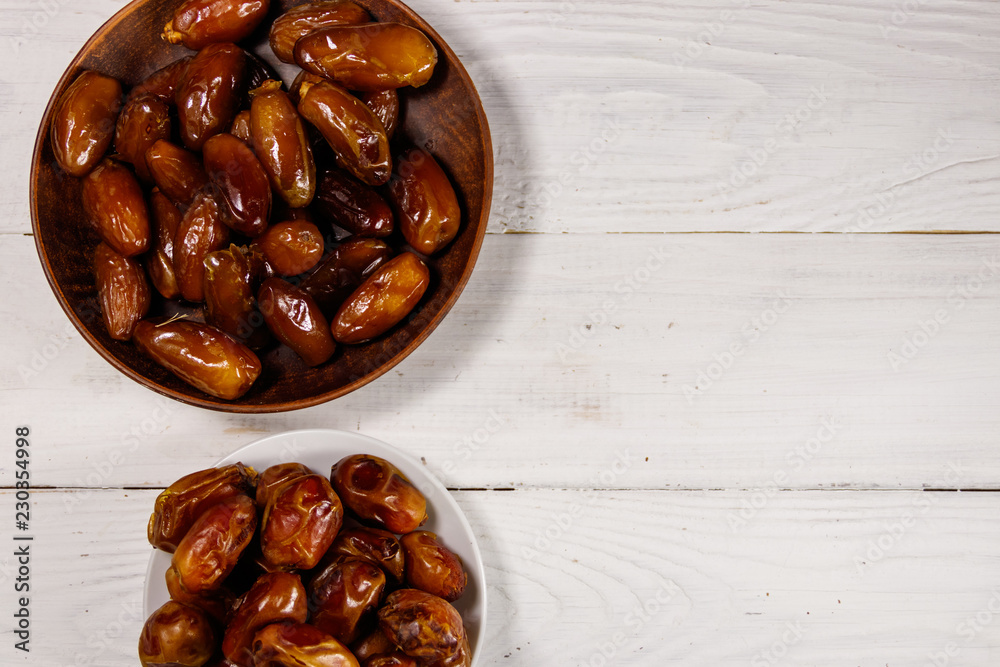 Dried dates fruit on white wooden table. Top view Dried dates fruit on white wooden table. Top view