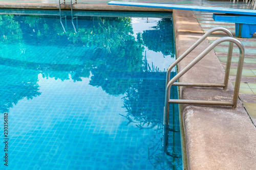 Grab bars ladder in the blue swimming pool © pandaclub23