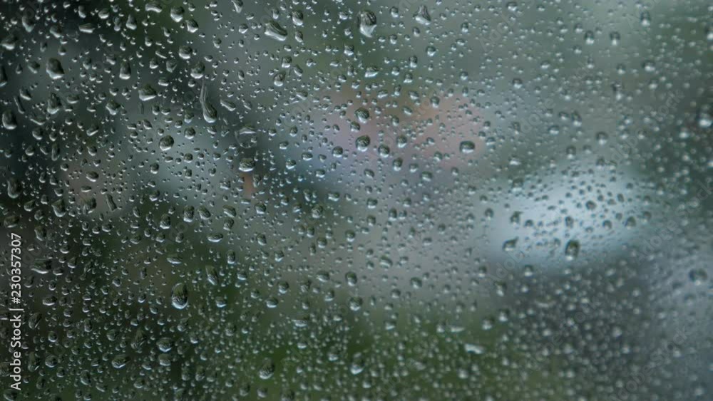 blurred traffic view through a car windscreen covered in rain for background. blurred traffic view through a car windscreen covered in rain for background.