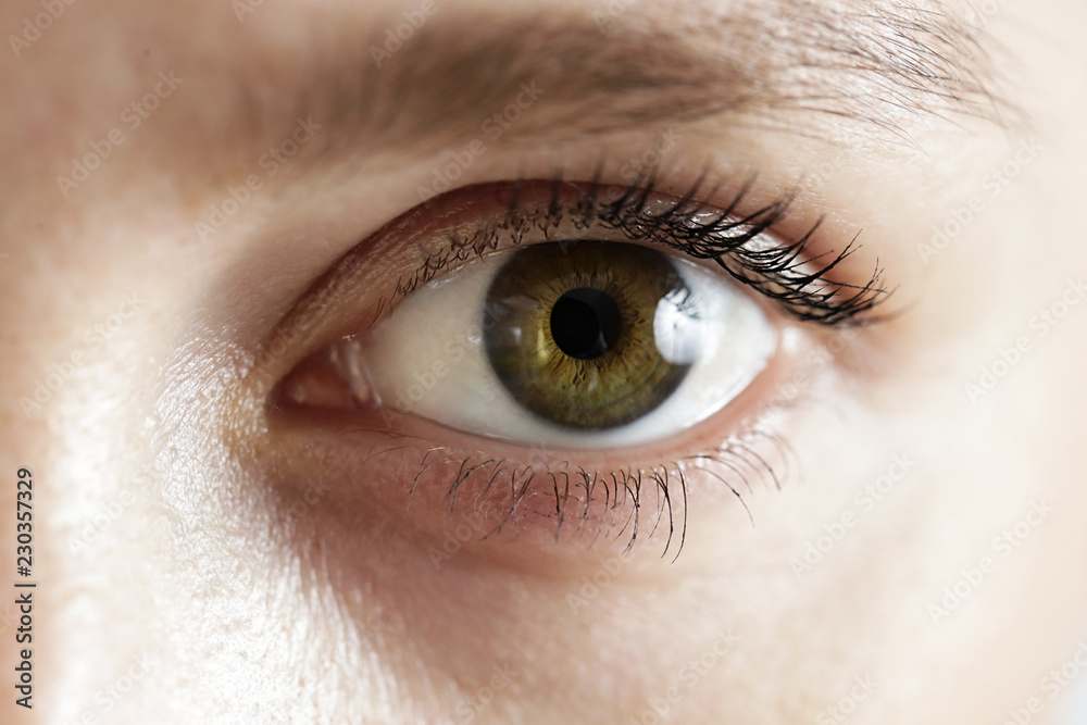 Obraz premium Close up view of a green woman eye - no make up on with natural skin texture 