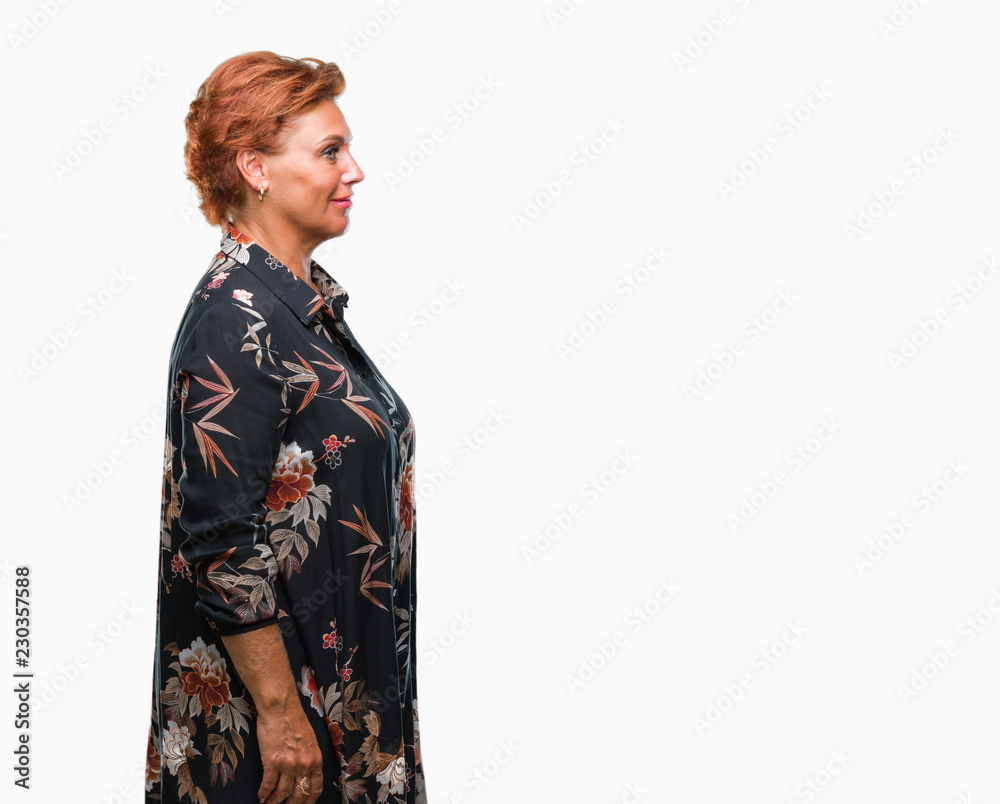 Atrractive senior caucasian redhead woman over isolated background looking to side, relax profile pose with natural face with confident smile.