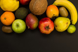 Variety of fruits isolated on black background. Top view of fresh fruits