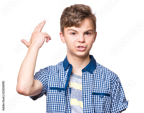 Teen boy making an imaginary gun shoot. Emotional portrait of bored teenager committing suicide with finger gun gesture. Child shooting hisself making finger pistol sign,  isolated on white background photo