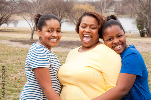 Happy African American Mother And Her Daughters.