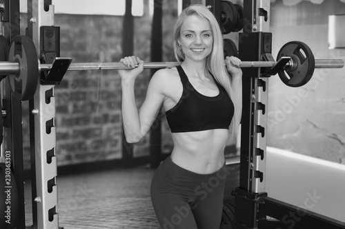 young fitness girl trains in the gym