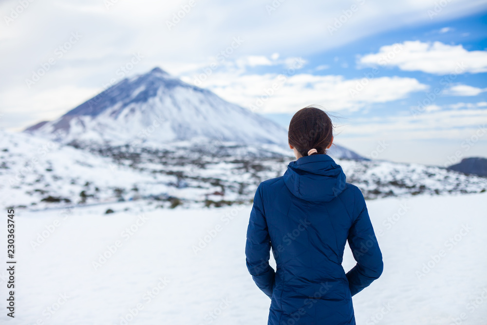Back view of traveler woman enjoy snow mountains