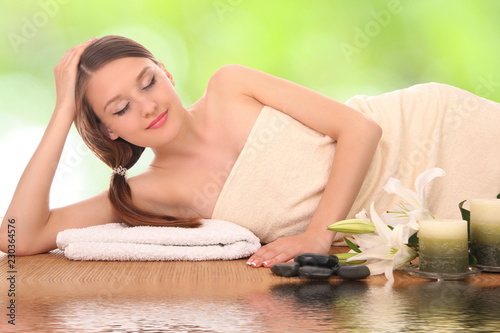 woman lying down relaxing on a massage bed at spa