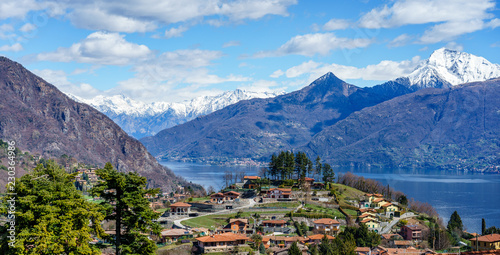 Small Village at lake como with majestic dolomoites in the background