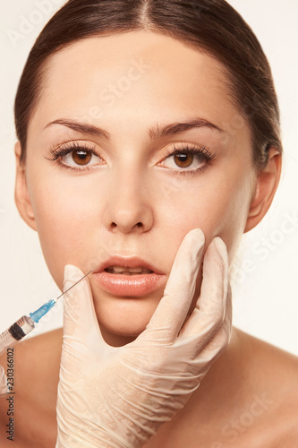 Medical filler for face woman. Anti wrinkle lip injection. Beauty plastic. Process big lip